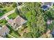 Aerial view of a beautiful home surrounded by lush trees and a lake, showcasing its prime location at 86 Black River Rd., Myrtle Beach, SC 29588