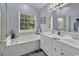 Bright bathroom with soaking tub, double vanity, and large window at 86 Black River Rd., Myrtle Beach, SC 29588