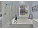 Bathroom boasts a glass-enclosed shower, soaking tub, and a bright window at 86 Black River Rd., Myrtle Beach, SC 29588