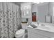Charming bathroom featuring a floral shower curtain and a bright vanity area at 86 Black River Rd., Myrtle Beach, SC 29588