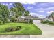 Beautiful one-story brick home with a well-kept lawn, mature trees, and attached garage at 86 Black River Rd., Myrtle Beach, SC 29588