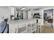 Open kitchen with bar seating, white cabinetry, stainless appliances, and laminate wood flooring at 86 Black River Rd., Myrtle Beach, SC 29588