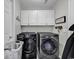 Laundry room with washer, dryer, and storage cabinets above at 86 Black River Rd., Myrtle Beach, SC 29588