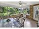 Screened porch with brick accent wall and outdoor dining setup overlooking the landscaped backyard at 86 Black River Rd., Myrtle Beach, SC 29588