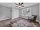 Bright bedroom featuring a ceiling fan, window view, and a cozy chair at 915 Palmetto St., Georgetown, SC 29440