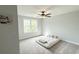 Bedroom featuring a ceiling fan, light gray walls and carpet, and a bright window at 915 Palmetto St., Georgetown, SC 29440