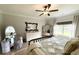 Bright bedroom with a stylish bed, ceiling fan, and large windows offering a view of the yard at 915 Palmetto St., Georgetown, SC 29440