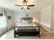 Comfortable bedroom features a stylish black bed, ceiling fan, and two bedside tables at 915 Palmetto St., Georgetown, SC 29440