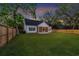 Home exterior showcasing a well-manicured lawn and fenced yard at dusk at 915 Palmetto St., Georgetown, SC 29440