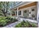 Charming front porch with a swing, beautiful landscaping, and a light teal door at 915 Palmetto St., Georgetown, SC 29440