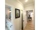 Hallway with views of bathroom and other rooms, featuring light wood floors at 915 Palmetto St., Georgetown, SC 29440