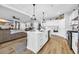 Modern kitchen featuring white cabinets, an island with seating, and an open layout to the living area at 915 Palmetto St., Georgetown, SC 29440