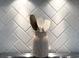 Close-up of a white herringbone backsplash with cooking utensils at 915 Palmetto St., Georgetown, SC 29440