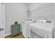 Bright laundry room features modern washer and dryer, storage cabinet, and wire shelving at 915 Palmetto St., Georgetown, SC 29440