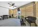 Relaxing screened-in porch with a ceiling fan, comfortable seating, and a grill at 915 Palmetto St., Georgetown, SC 29440
