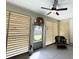 Cozy screened porch with louvers, outdoor seating, ceiling fan, and decorative wreath at 915 Palmetto St., Georgetown, SC 29440