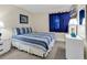 Cozy bedroom with blue-striped bedding, nautical decor, and a bright window at 9581 Shore Dr. # 127, Myrtle Beach, SC 29572