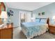 Charming bedroom with light blue walls, balcony access and coordinating decor at 9581 Shore Dr. # 127, Myrtle Beach, SC 29572