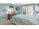 Bright bedroom with carpeted floors, balcony and a dresser with mounted television at 9581 Shore Dr. # 127, Myrtle Beach, SC 29572