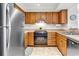 Efficient kitchen with stainless steel refrigerator, wood cabinets, and neutral countertops at 9581 Shore Dr. # 127, Myrtle Beach, SC 29572