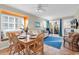 Cozy living and dining area with tile floors, large windows, and access to an outdoor balcony at 9581 Shore Dr. # 127, Myrtle Beach, SC 29572