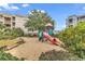 A charming playground with a slide and climbing structure with lush landscaping sits on the property at 9581 Shore Dr. # 127, Myrtle Beach, SC 29572