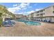 Resort pool featuring ample lounge chairs, a covered picnic area, and lush landscaping at 9581 Shore Dr. # 127, Myrtle Beach, SC 29572