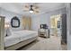 Inviting bedroom with a ceiling fan, decorative mirror, and ensuite bathroom at 100 North Beach Blvd. # 515, North Myrtle Beach, SC 29582