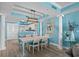 Dining room with stylish lighting and column accents open to the kitchen and living room at 100 North Beach Blvd. # 515, North Myrtle Beach, SC 29582