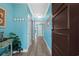 Hallway features light blue walls, plank flooring, white trim, and a dark wood door at 100 North Beach Blvd. # 515, North Myrtle Beach, SC 29582