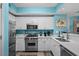 Kitchen featuring stainless appliances, white cabinetry, and solid surface countertops at 100 North Beach Blvd. # 515, North Myrtle Beach, SC 29582