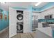 Convenient laundry closet with stacked washer and dryer in the kitchen area at 100 North Beach Blvd. # 515, North Myrtle Beach, SC 29582