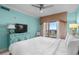 Bedroom with a balcony view, large bed and TV, complemented by a turquoise accent at 100 North Beach Blvd. # 515, North Myrtle Beach, SC 29582