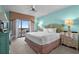 Bedroom with balcony access and large bed, bedside tables, and lamps at 100 North Beach Blvd. # 515, North Myrtle Beach, SC 29582