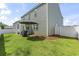 Fenced backyard with lush green grass, patio, grill, and an umbrella for shade at 1020 Sennema Circle, Myrtle Beach, SC 29588