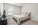 Bedroom with a neutral-colored bed, natural light, neutral paint, and carpet at 1020 Sennema Circle, Myrtle Beach, SC 29588