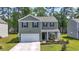 Charming two-story home featuring a welcoming front porch, manicured lawn, and attached two-car garage at 1020 Sennema Circle, Myrtle Beach, SC 29588