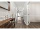 Hallway with hardwood floors, decorative console table, and doors leading to various rooms at 1020 Sennema Circle, Myrtle Beach, SC 29588