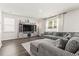 Comfortable living room with hardwood floors, sectional sofa, and modern entertainment center at 1020 Sennema Circle, Myrtle Beach, SC 29588