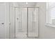 Modern walk-in shower with sliding glass doors and a window at 1020 Sennema Circle, Myrtle Beach, SC 29588