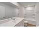 Modern bathroom boasts a large mirror, white countertops, and a shower-tub combo with tiled surround at 1023 Laconic Dr., Myrtle Beach, SC 29588