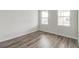 Bright bedroom with hardwood flooring, two windows offering natural light, and neutral walls at 1023 Laconic Dr., Myrtle Beach, SC 29588
