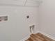 Well-lit laundry area with wood-look flooring, hookups, and convenient storage shelving at 1023 Laconic Dr., Myrtle Beach, SC 29588