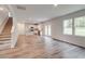 Open living space leading to kitchen with hardwood floors and windows overlooking backyard views at 1023 Laconic Dr., Myrtle Beach, SC 29588