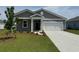 Charming one-story home with gray siding, well-manicured lawn, and attached two-car garage at 1034 Laconic Dr., Myrtle Beach, SC 29588