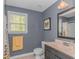 Bathroom featuring modern vanity, toilet, mirror and window for natural light at 1050 Hagley Dr., Pawleys Island, SC 29585