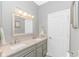 Bathroom with gray double sink vanity, decorative lighting, and large mirror at 1050 Hagley Dr., Pawleys Island, SC 29585