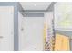 Modern bathroom with shower, curtain, yellow towel and window for natural light at 1050 Hagley Dr., Pawleys Island, SC 29585