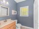 This bathroom features a wooden vanity, modern toilet, and window that lets in natural light at 1050 Hagley Dr., Pawleys Island, SC 29585