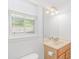Bright bathroom with a tan vanity, large mirror, and natural light from the window at 1050 Hagley Dr., Pawleys Island, SC 29585